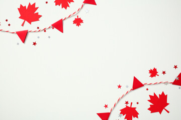 Canada Day festive frame. Red maple leaves and triangle paper bunting garland border on white...