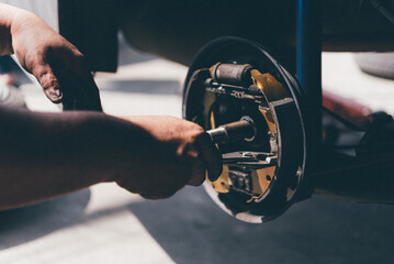 Drum brake and asbestos brake pads at car garage