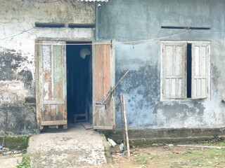 Old abandoned house with weathered walls and broken windows. Perfect for themes of decay, urban...