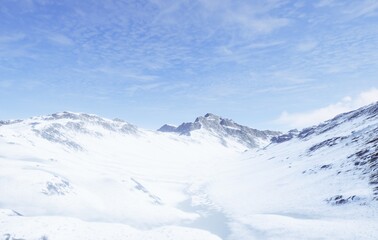 Behold the Majestic Aerial View of the SnowCapped Mountains Beneath a Clear Blue Sky