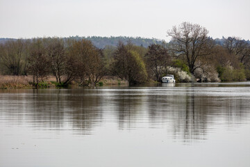Boat moored along River Thames with spring blossom, Goring-on-Thames, Oxfordshire, England, United...