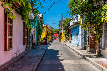 Fototapeta premium A view down a colourful backstreet in the Getsemani district of Cartagena, Columbia in springtime