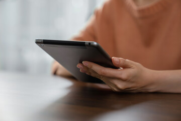 woman hand holding digital tablet and touching on screen.