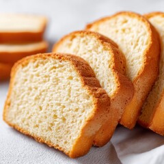 Fototapeta premium Keto lifestyle low carb recipes concept. Freshly Sliced Loaf of Soft White Bread on a Light Surface with Golden Brown Crust