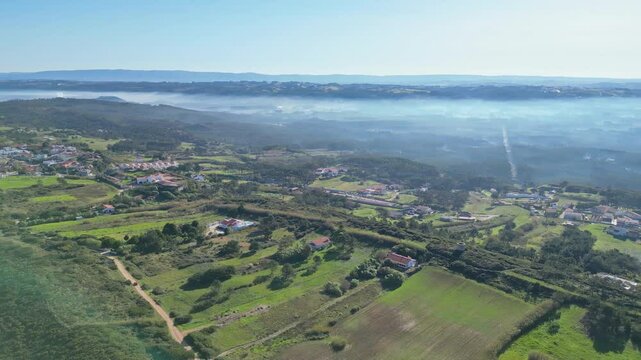 Green hills and houses near miradouro do salgado, nazar&eacute;, portugal, aerial view