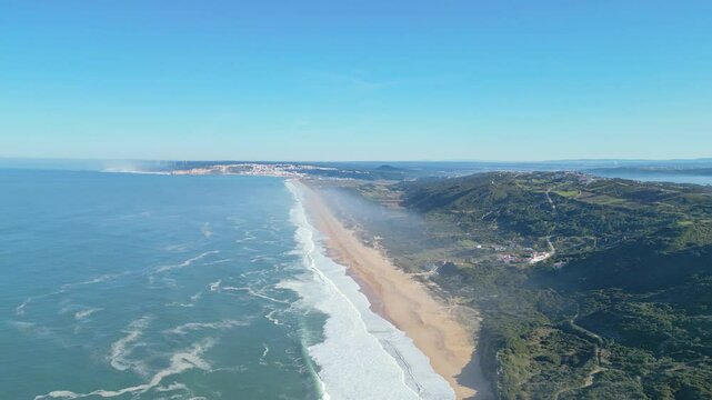 Miradouro do salgado beach with waves and hills in nazar&eacute;, portugal, aerial view