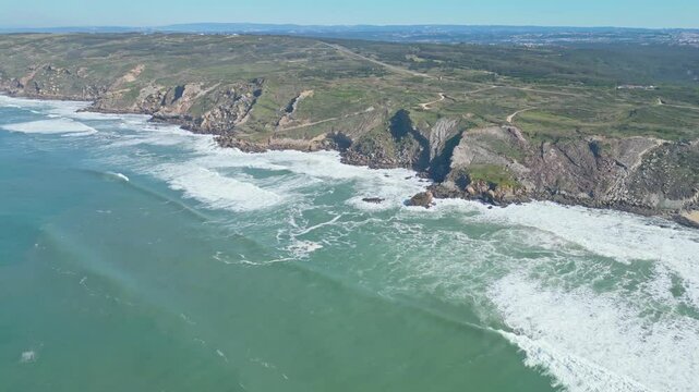 Cliffs and waves at miradouro da salgado, nazar&eacute;, portugal coast, aerial view