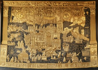 Intricate golden relief depicting a complex historical or mythical narrative scene