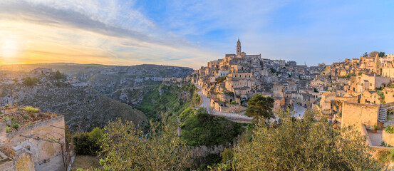 Cityscape of the Sassi di Matera at sunrise, in Basilicata, Southern Italy: view of the Sasso Barisano district overlooking the ravine of the Murgia Materana with cave houses.
