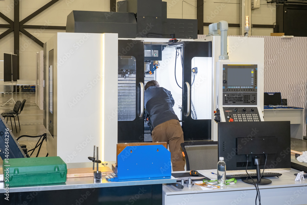 Poster modern workshop with cnc machine. man near milling equipment. table with computers inside production