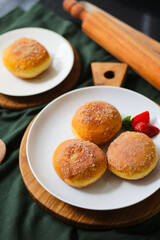 A handmade bombolone or bomboloni is an Italian-filled doughnut that is eaten as a snack or dessert. Selective focus.