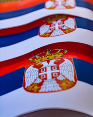 Obraz premium Close up of Serbian flags with the coat of arms
