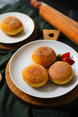 A handmade bombolone or bomboloni is an Italian-filled doughnut that is eaten as a snack or dessert. Selective focus.