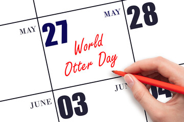 May 27. Hand writing text World Otter Day on calendar date. Save the date.