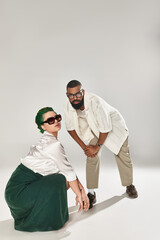 Stylish multicultural couple expressing individuality in a studio setting