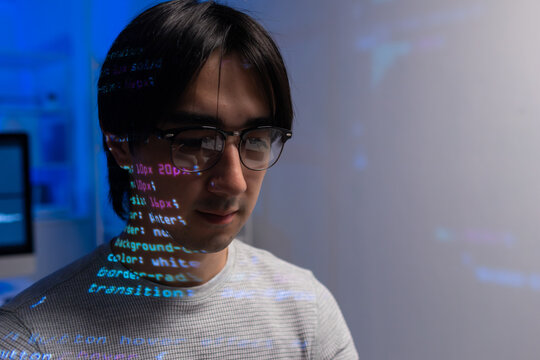 Young caucasian male software developer working on computer for coding software program in office. Focused male programmer coding on desktop computer, programming, cyber security, web development.