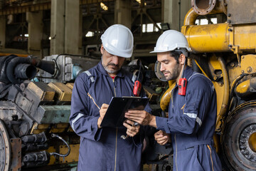 Engineer train engine service team working together at train depot locomotive industry Electric train technician engineer checking controls system for security functions in maintenance infrastructure 