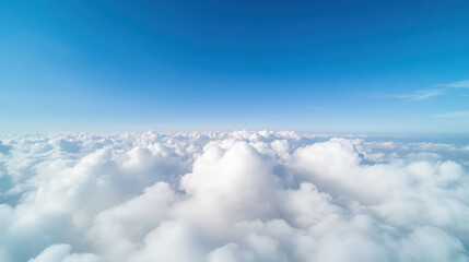 Fototapeta premium Fluffy clouds stretch across bright blue sky, creating serene and peaceful atmosphere