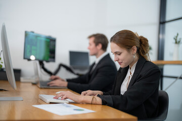 Professional colleagues working diligently in a modern office space during the day