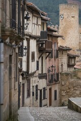 Narrow stone streets with medieval brown houses and balconies in their windows.