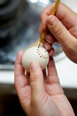 The process of painting Easter eggs, using bees wax as traditional Lithuanian method
