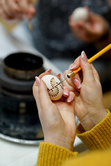 The process of painting Easter eggs, using bees wax as traditional Lithuanian method