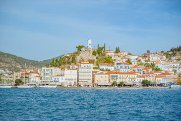 Obraz premium Poros Island, Saronic, Greece: Greek island townscape with blue water and sky