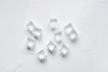Melting ice cubes in a splash of water on a white background
