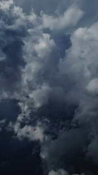 Lot of lightning during a thunderstorm. Storm clouds are moving fast on the viewer, timelapse. Vertical video