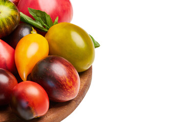 Multicolored tomatoes: red, yellow, orange, green on a round wooden board on a white background. Close-up view from above. Place for captions