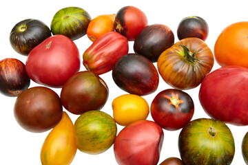 Colorful raw tomatoes: red, yellow, orange, green on a white background. Ripe, juicy, different colors and shapes. Close-up side view
