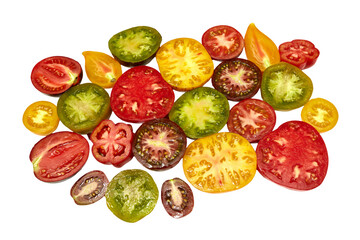 Colorful raw tomatoes cut in half: red, yellow, green, brown and orange. Ripe and juicy. Close-up view from the top on a white background