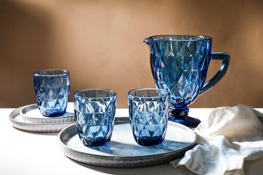 Blue faceted jug, glasses and plate