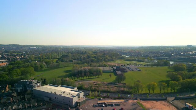 Wide, forward travelling aerial of Ormeau Park in Belfast, Northern Ireland on a warm, sunny summer day. Filmed in 4K, 60 frames per second and in Rec709 Color.