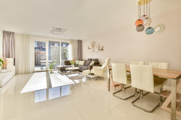 A spacious and bright modern living room featuring elegant furniture, large windows, and stylish decor elements that enhance the atmosphere of comfort and tranquility.