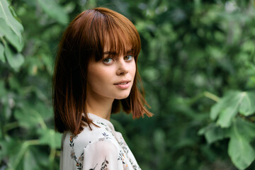Serenity in nature young woman with short hair surrounded by lush green trees and plants