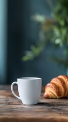 White Mug Mockup with Croissant on Wooden Table, Dark Blue and Grey Palette