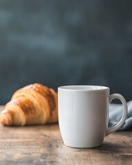 White Mug Mockup with Croissant on Wooden Table, Dark Blue and Grey Palette