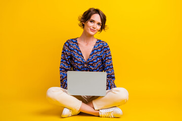 Full length body photo of young lady sitting floor with netbook doing her job in remote location...