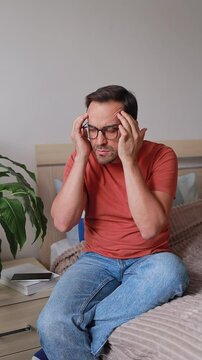Vertical Video Man Massages His Temples Because Of Headache In Apartment