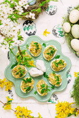 Easter deviled eggs with fried champignons on Easter background..top veiw