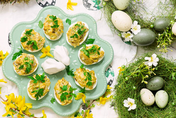 Easter deviled eggs with fried champignons on Easter background..top veiw