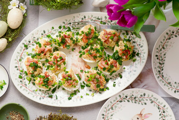 Eggs stuffed with bacon and green onions on Easter background..top veiw
