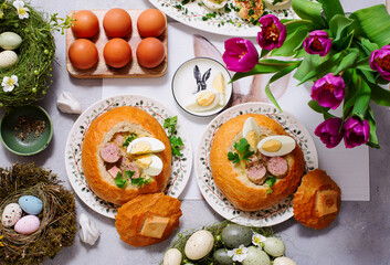 Traditional Polish Easter soup zurek served in a loaf of bread, smoked meats and egg..top veiw