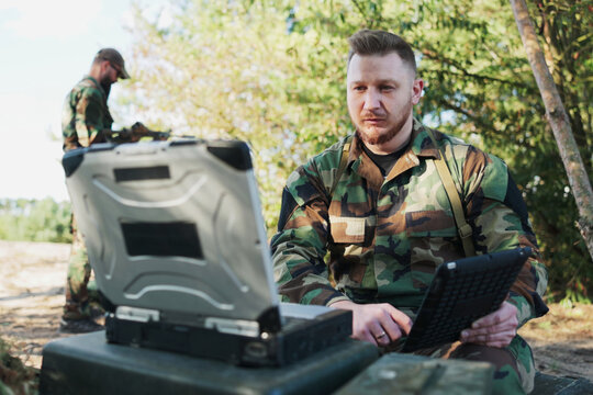 In the field, the army commander engages in a video call with the head of the army base, providing mission details, discussing precautions, and sharing secret information.