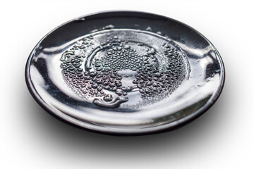 Wet black plate, covered with water drops. isolated on white