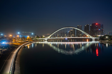 The glowing bridges and city skyline on the river at night, Chengdu, China
