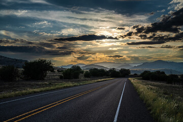 Dramatic sky over mountainous range at the end of a 2 lane highway as the sun setting, Mt Livermore, Highway 118, Davis Mountain, McDonald Observatory, Texas