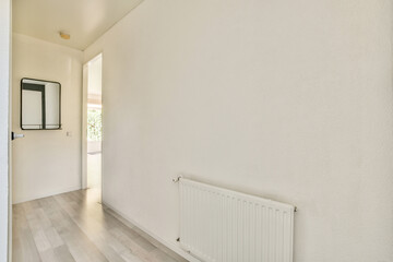 A spacious, minimalist interior showcasing a bright hallway with a clean aesthetic. The design emphasizes light colors and simple lines for a modern feel.
