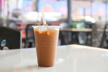 Iced Malaysian Milk Tea in Plastic Cup at Food Court Table